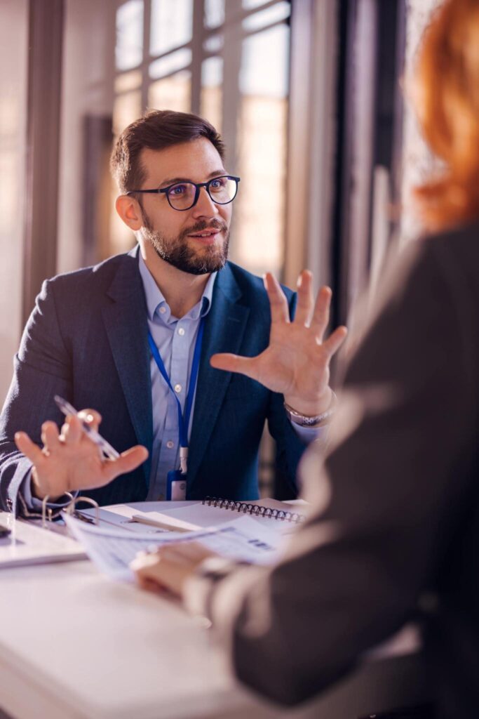 Professional business meeting with a confident businessman discussing strategy in an office setting